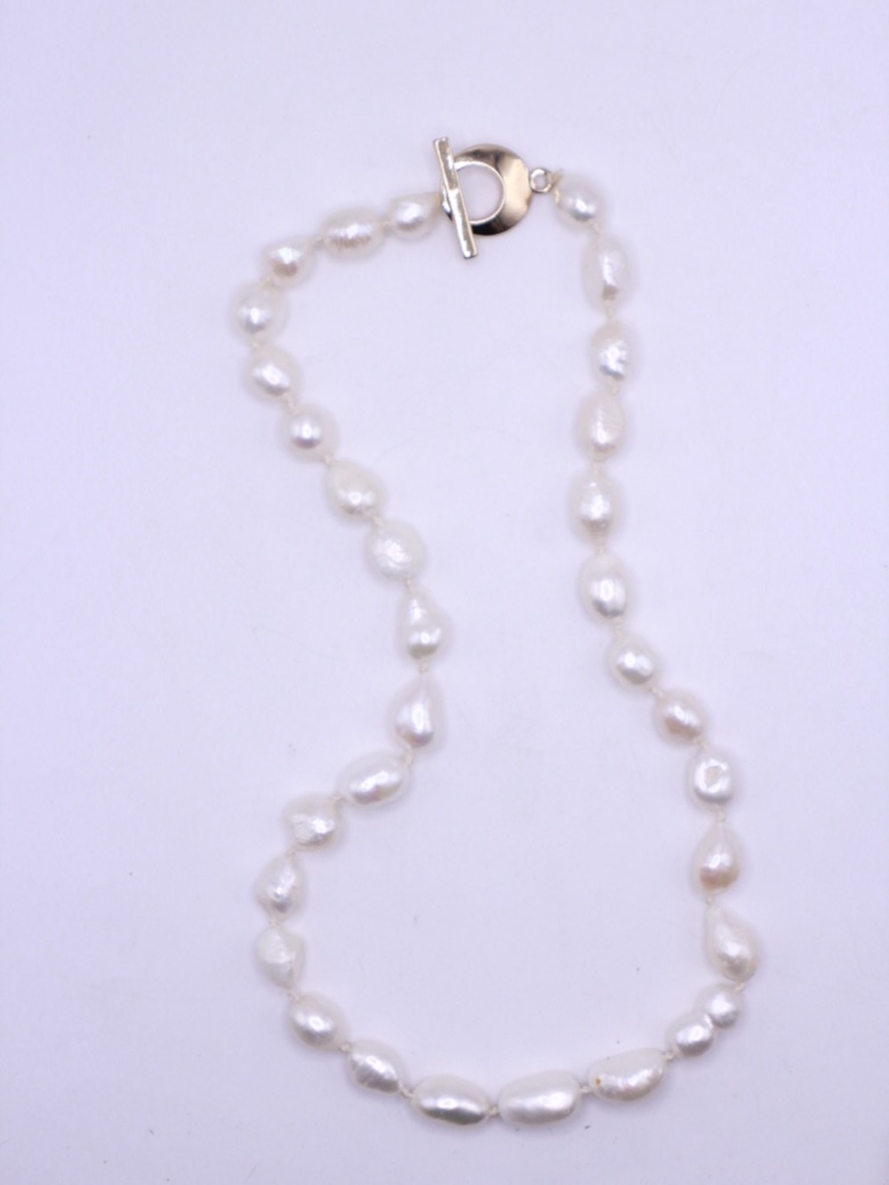 white freshwater baroque pearl necklace with a gold tone toggle clasp